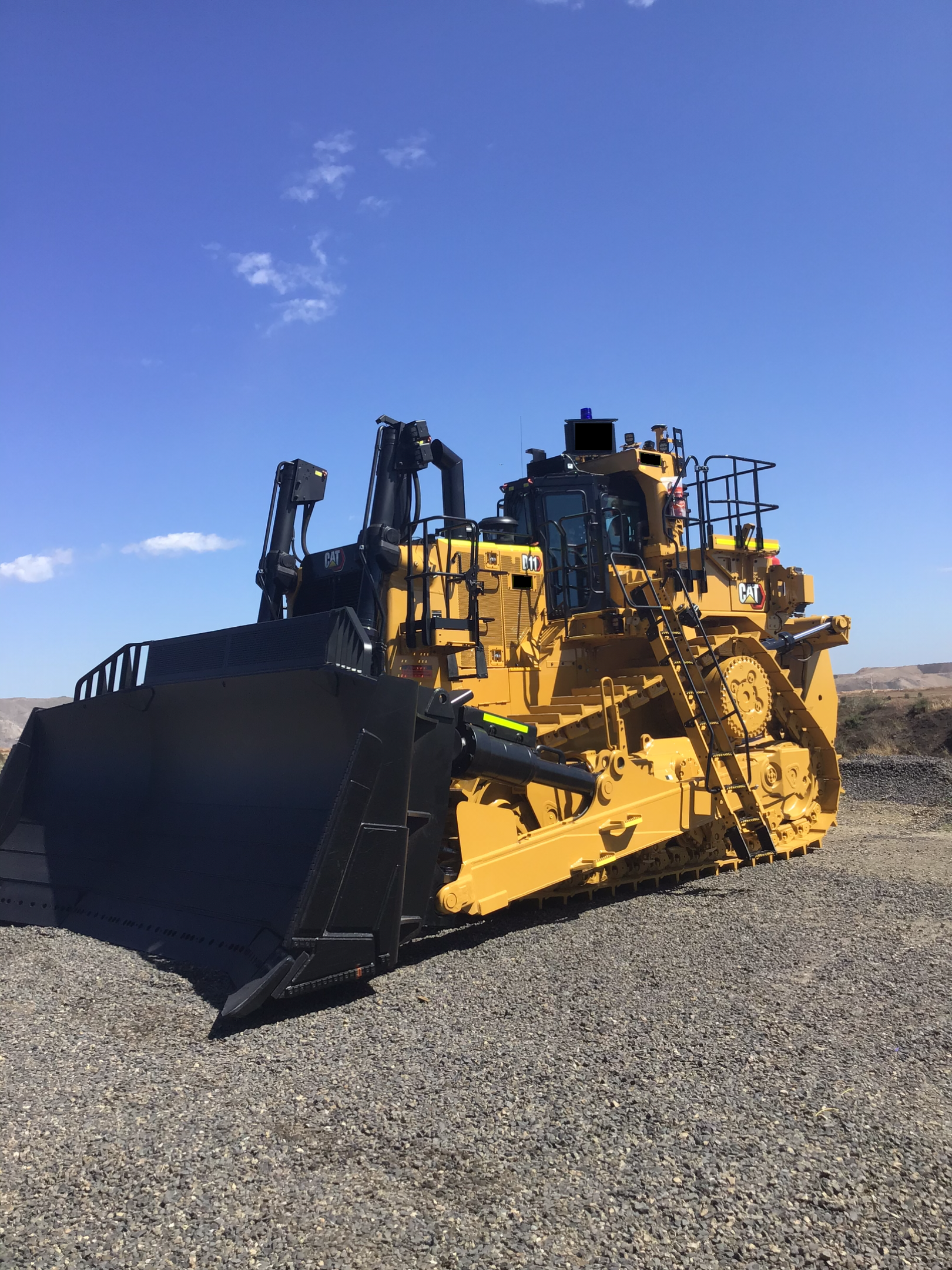 Yellow Caterpillar Bulldozer on Gravel Under a Blue Sky — PBC Compliancing in Paget, QLD