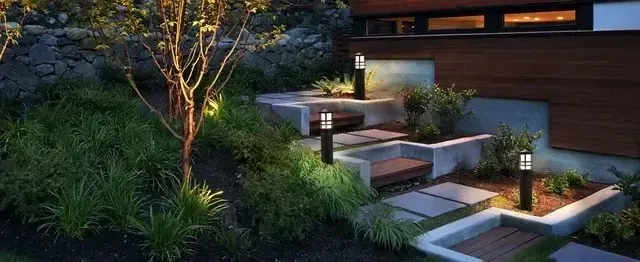 Local Electricians - This image showcases a modern residential landscape with strategically placed LED path lights illuminating concrete steps and garden walkways.