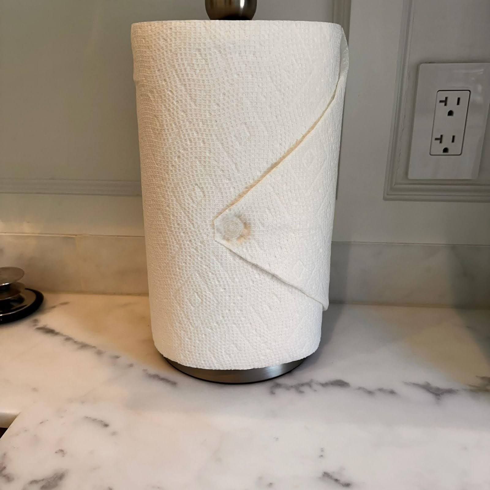 A roll of paper towels is sitting on top of a marble counter.