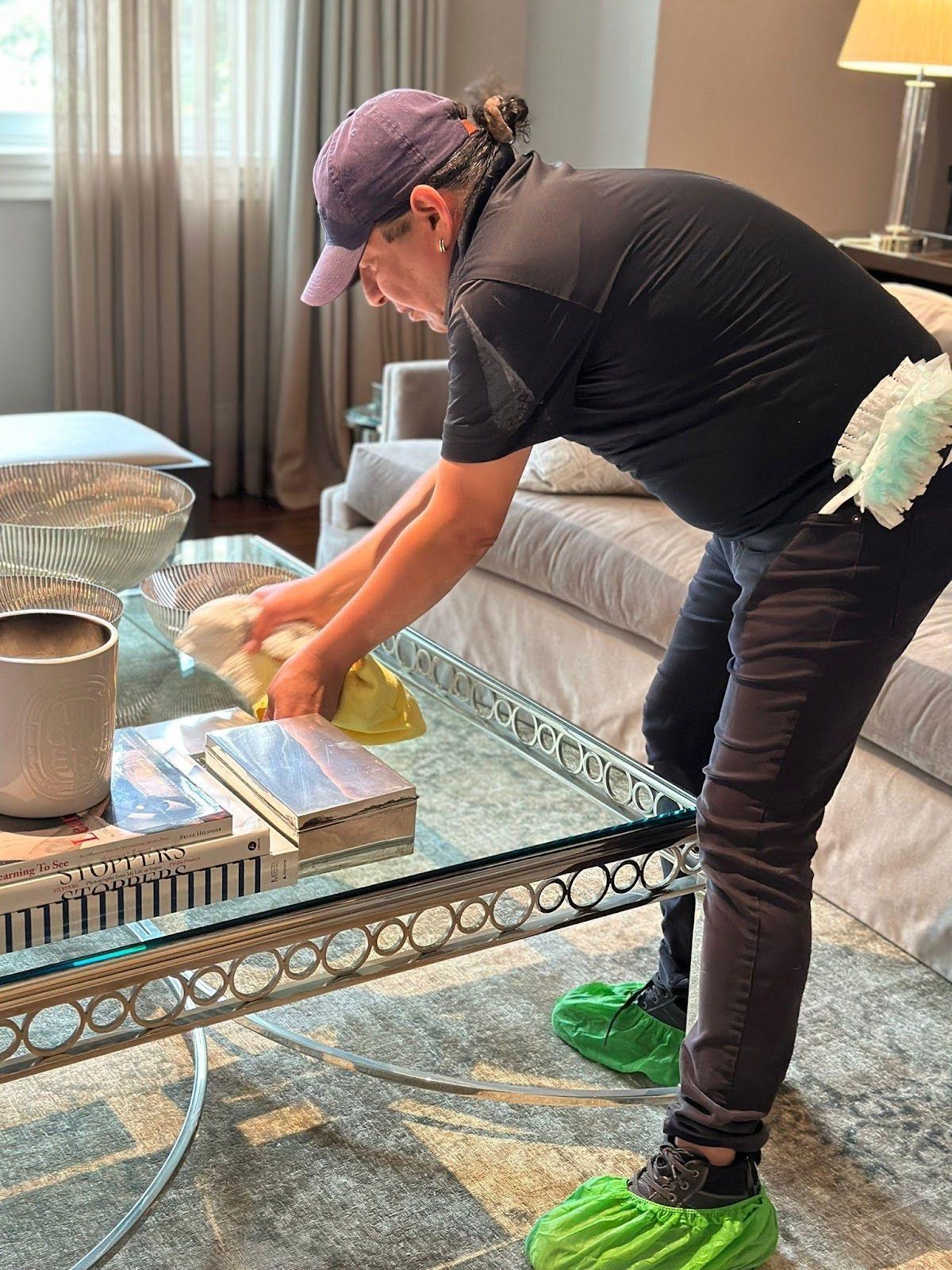 A woman is sweeping the floor with a broom and a scoop.