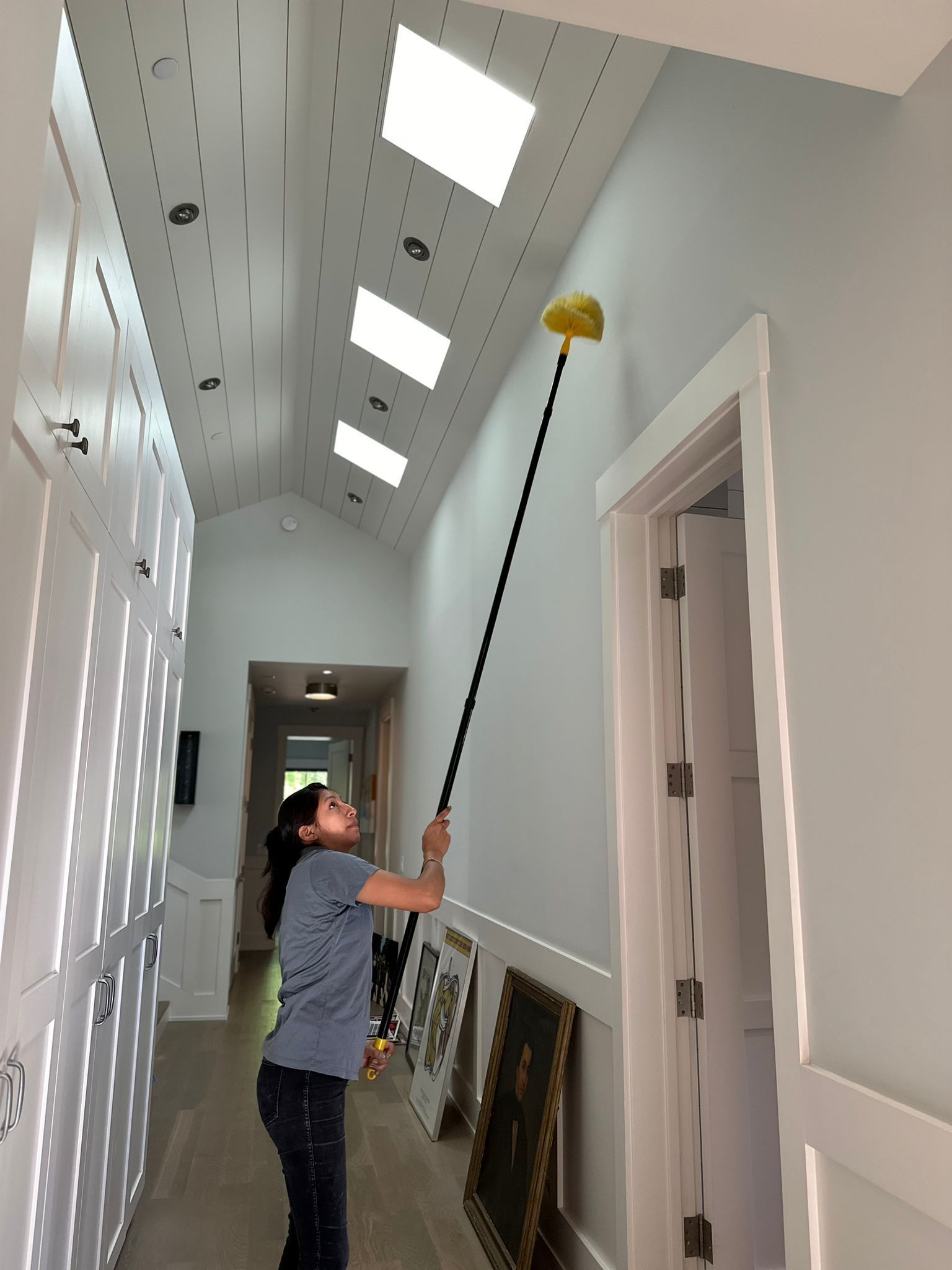 A person wearing gloves is cleaning a table with a cloth and spray.