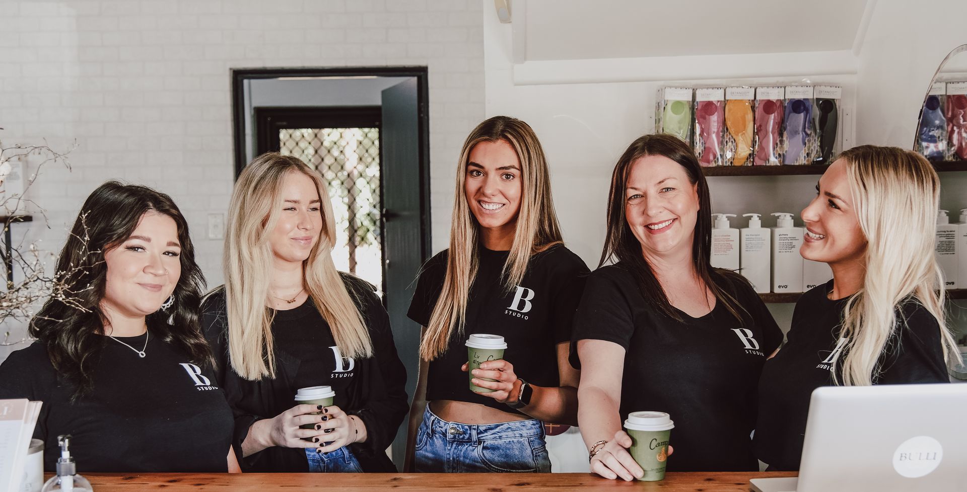 Team Holding a Coffee at the Salon — Hairdressers in Bulli NSW