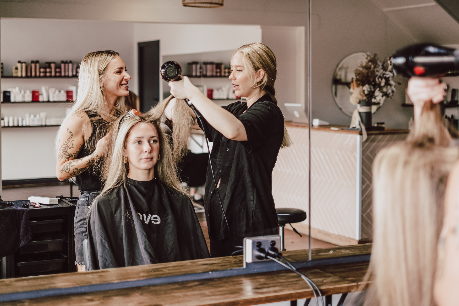 Woman with Two Hair Stylist at Hair Salon — Hairdressers in Bulli NSW