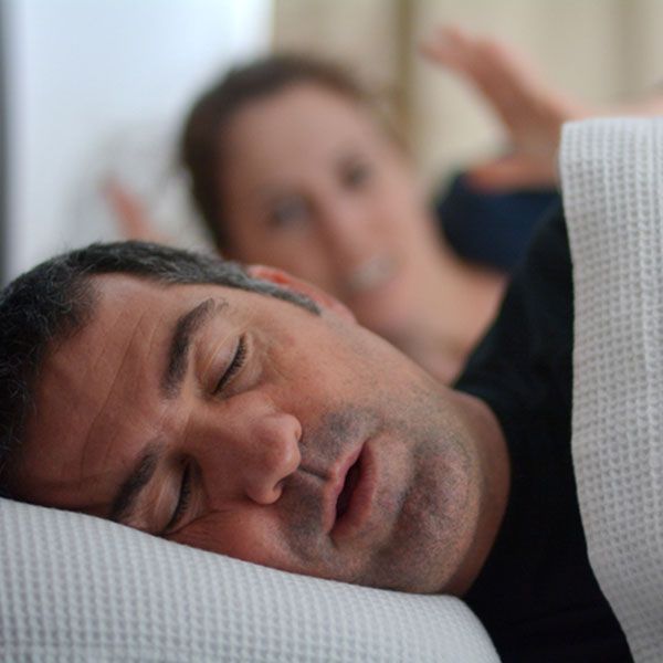 Woman suffers from her male partner snoring in bed