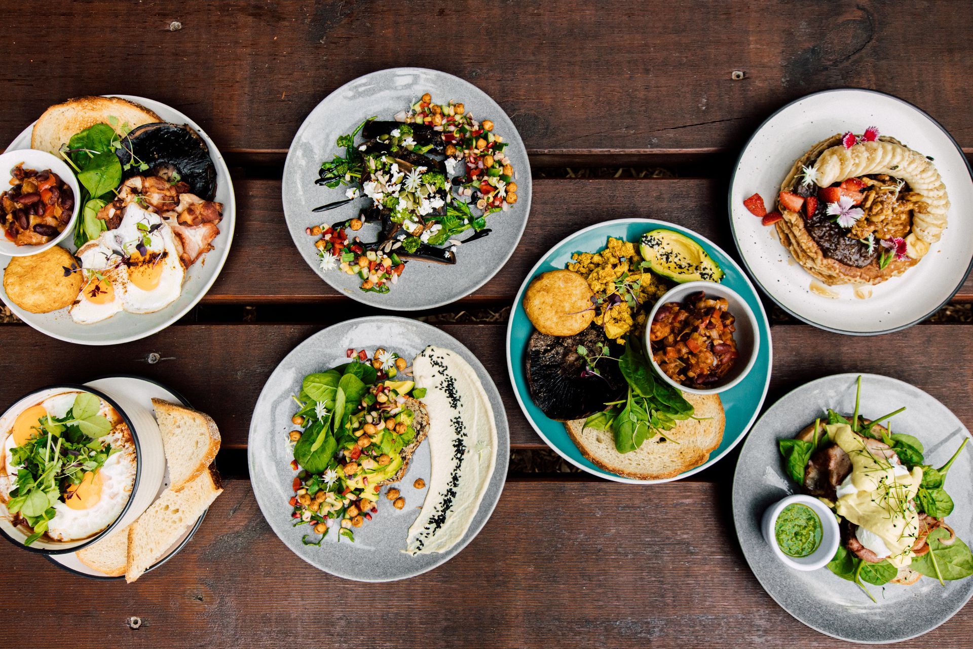 There are many different types of food on the plates on the table.