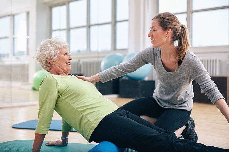 Chiropractor stretching senior women body