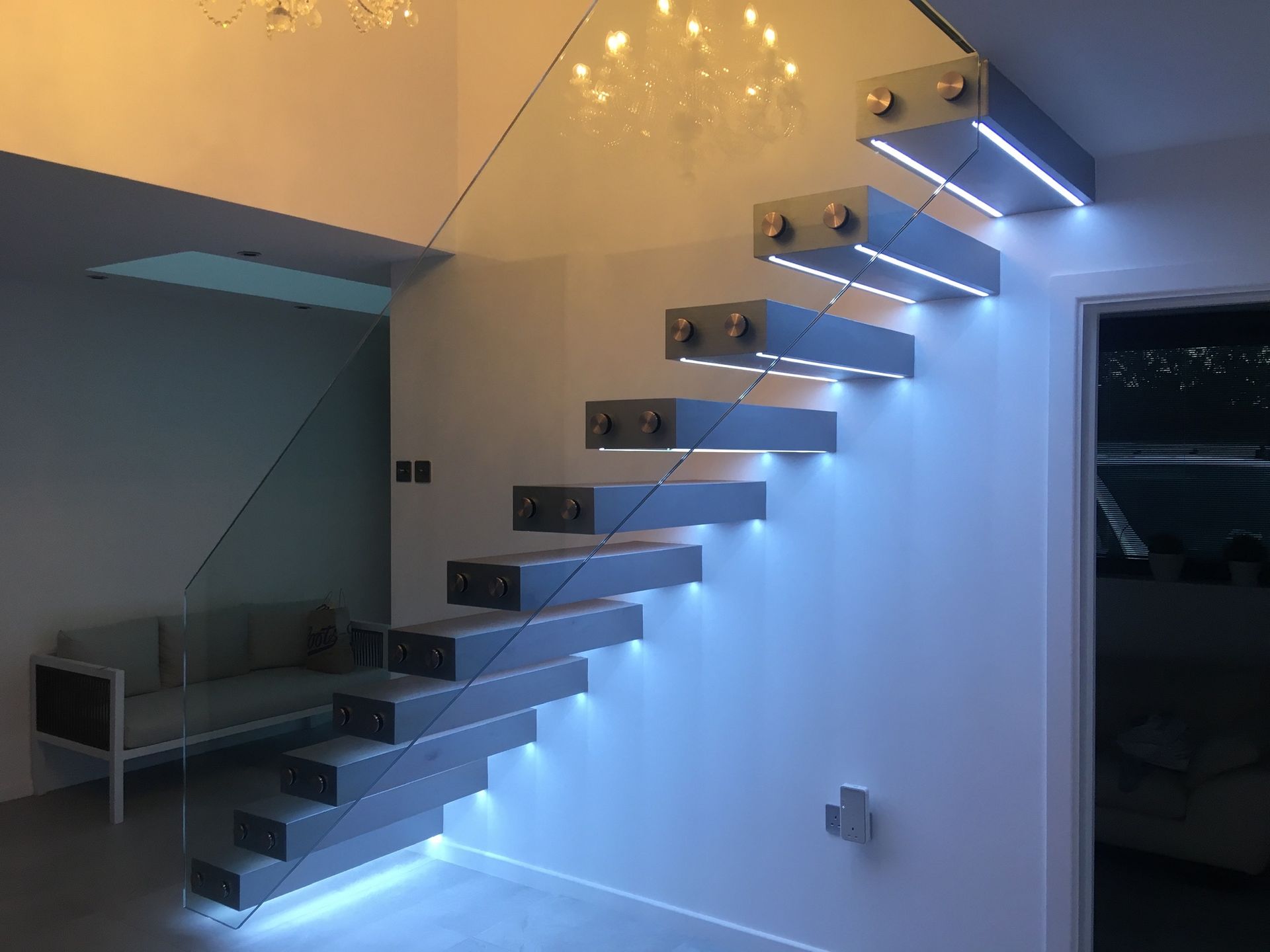 Floating staircase with integrated LED lighting and minimalist design – London home