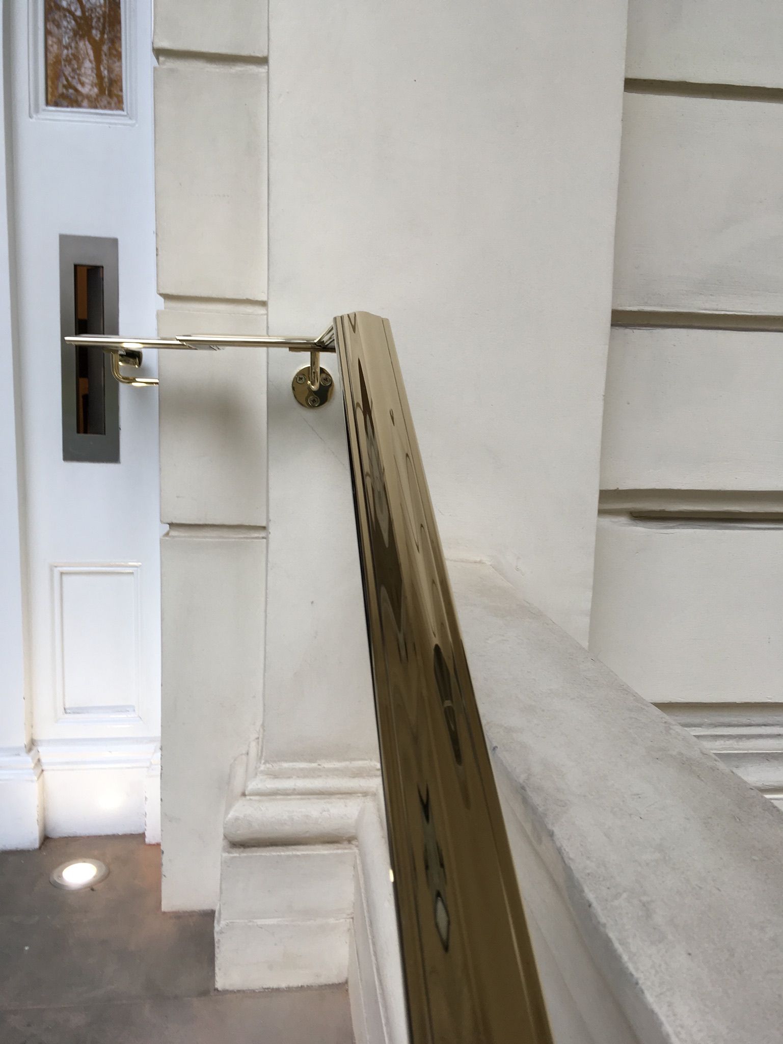 Brass handrail and custom bracket – premium metal finishing detail, London residence