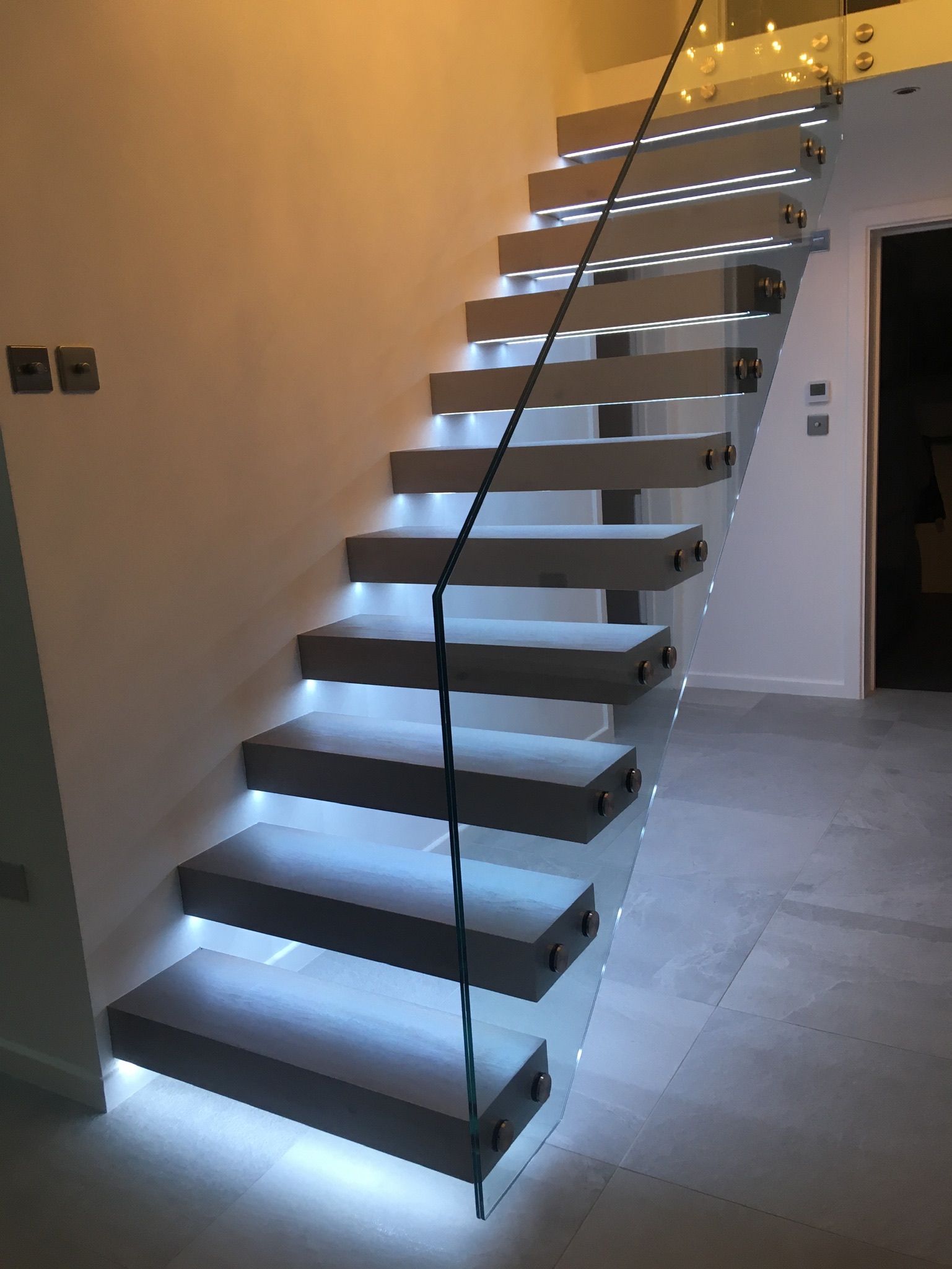 Bespoke steel staircase with glass railing and concealed fixings – premium finish