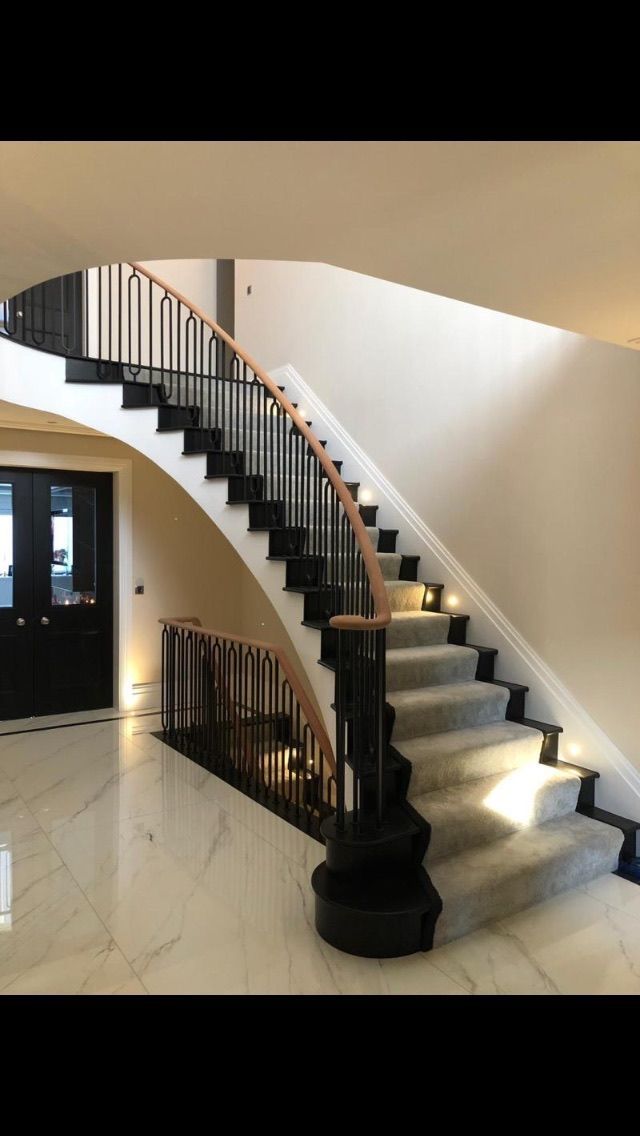 Curved staircase with custom steel balustrade – premium bespoke staircase installation