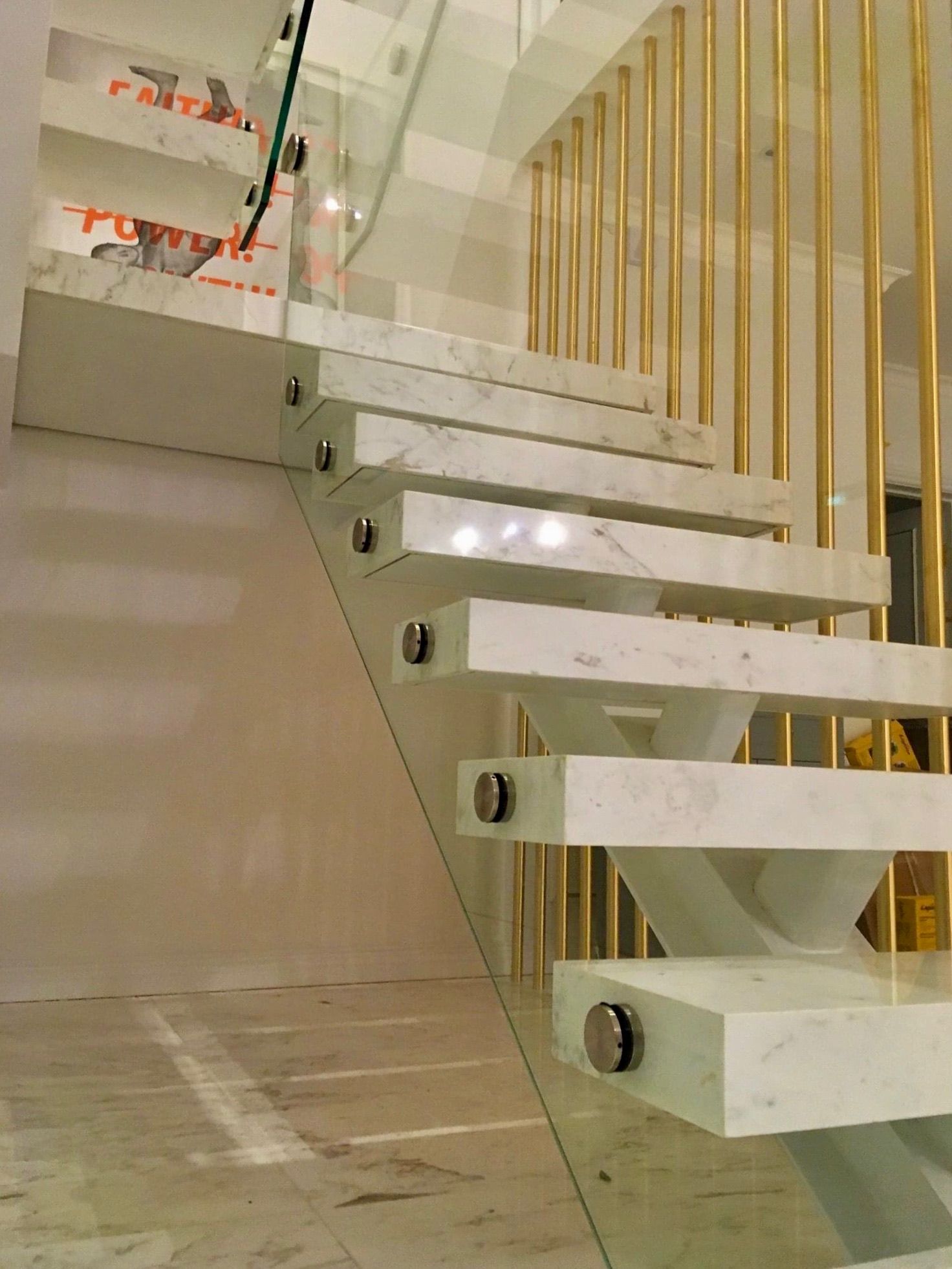 Marble and steel staircase with glass balustrade – high-end residential project