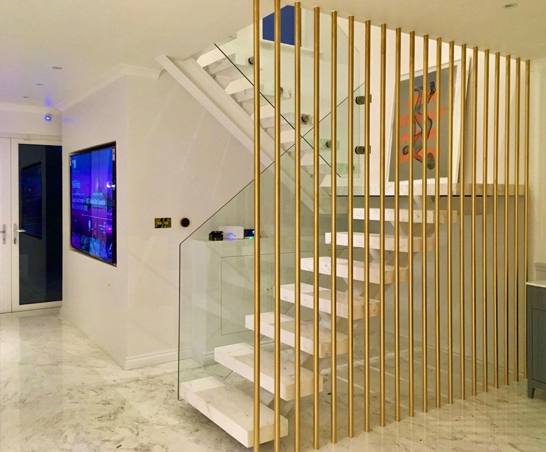 Glass and steel staircase with brass vertical balustrade – bespoke London interior