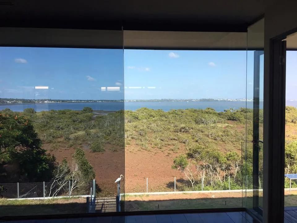 A Large Window with A View of A Field and A Body of Water — Solarmaster in East Brisbane, QLD