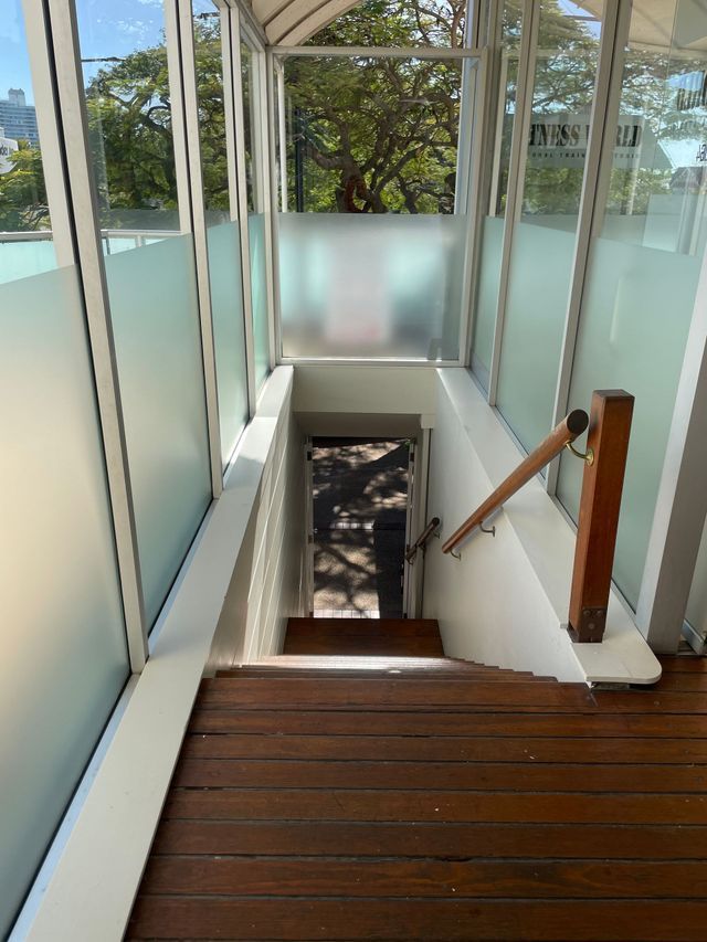 A Staircase With a Wooden Railing and a Glass Wall — Solarmaster in East Brisbane, QLD