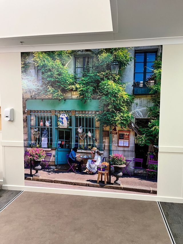A Wall With a Picture of People Sitting at Tables in Front of a Building — Solarmaster in East Brisbane, QLD