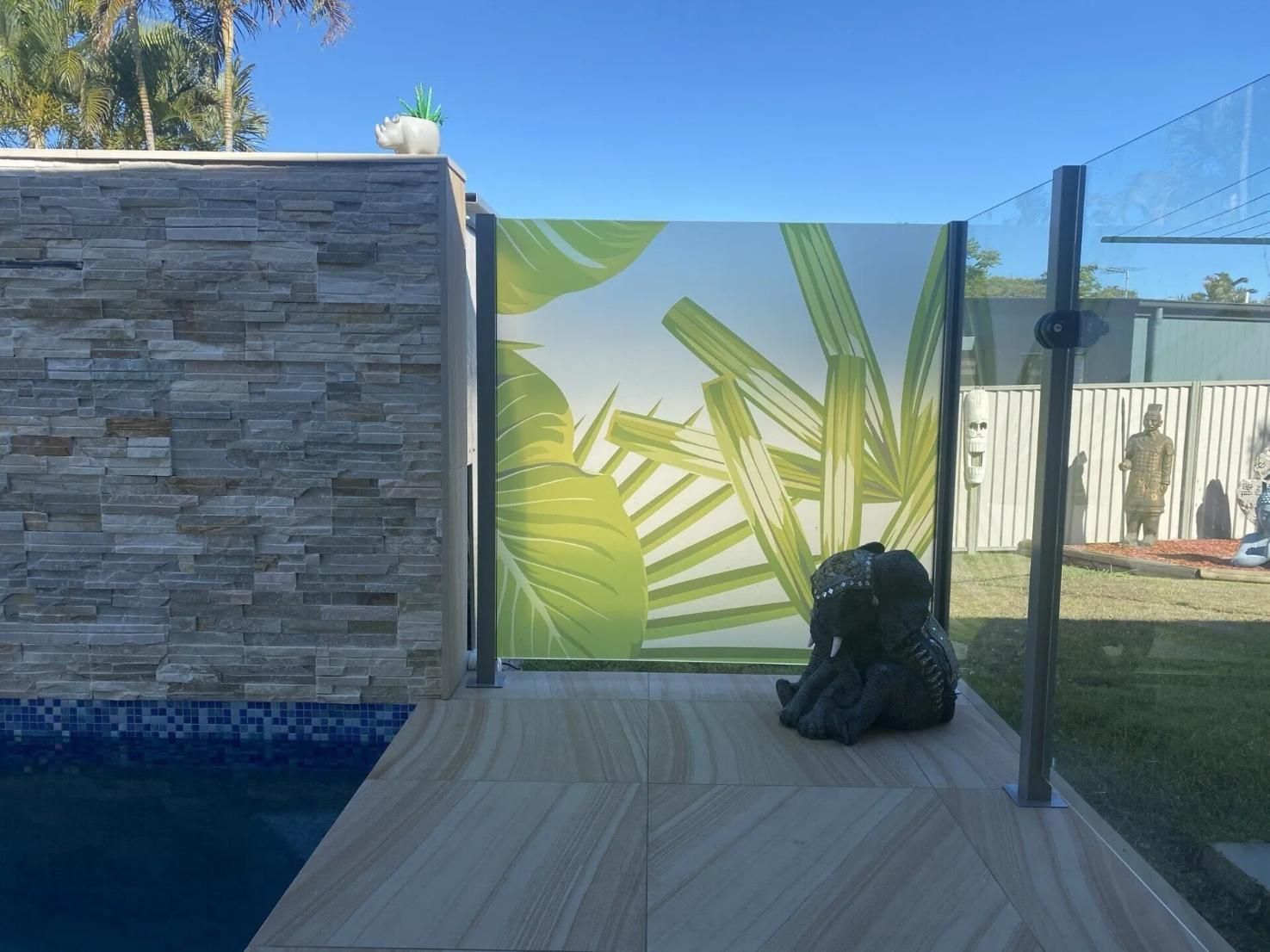 A Statue Is Sitting on A Tiled Floor Next to A Pool — Solarmaster in Gold Coast, QLD