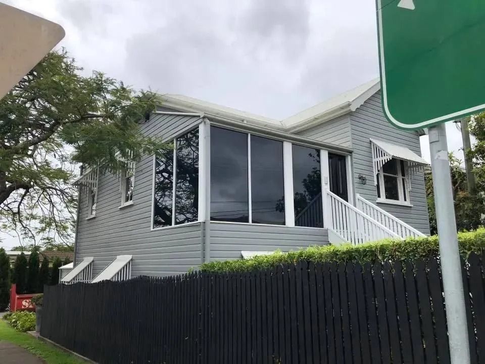 Wooden House With Large Modern Tinted Windows