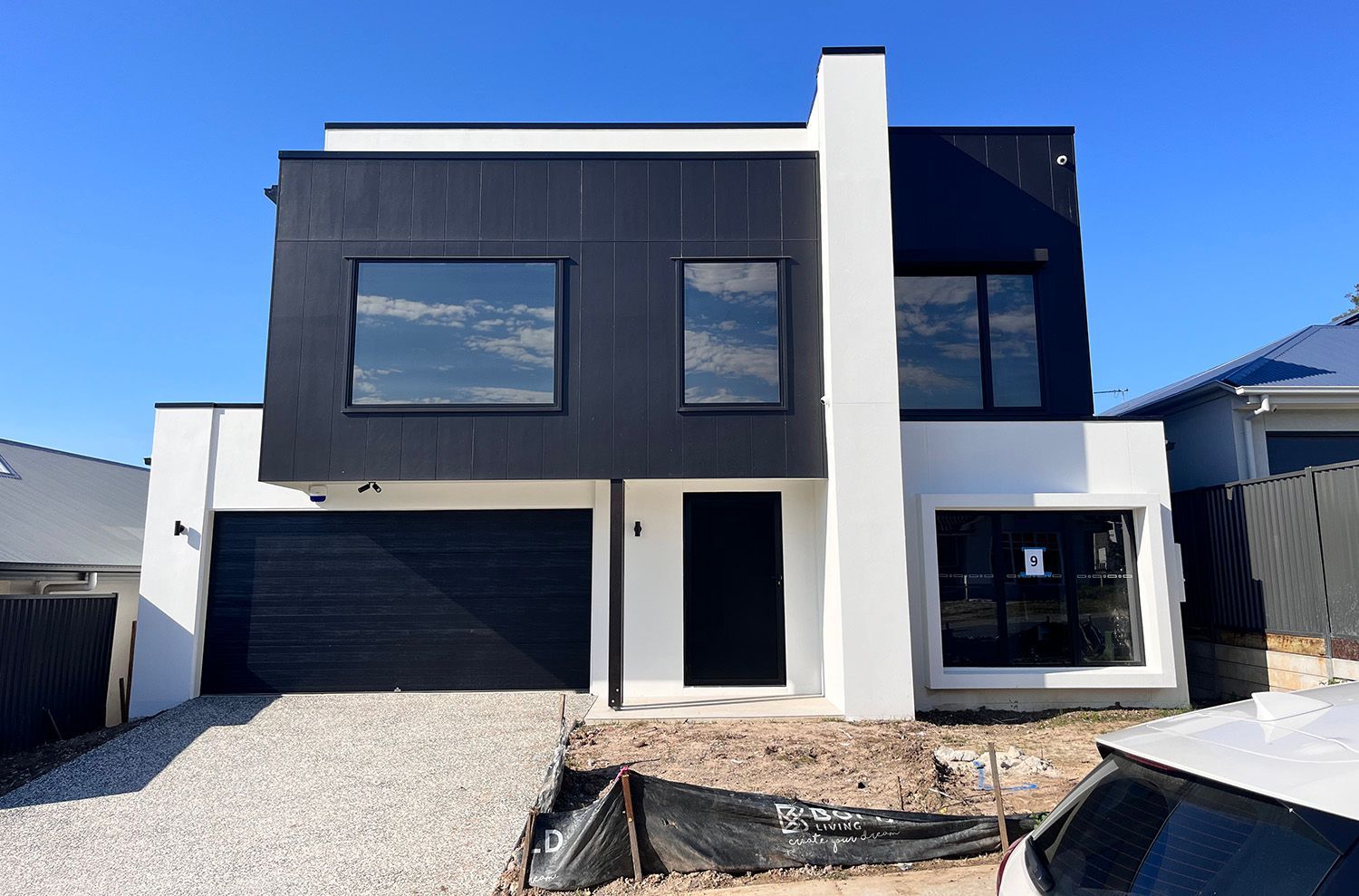 Modern Two-Story Black And White House With Tinted Windows