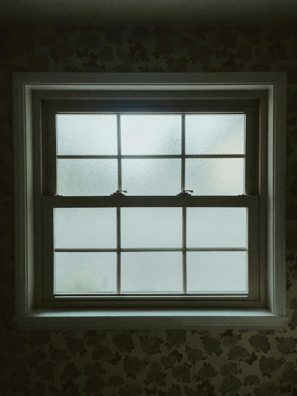 A Close up Of a Window with Frosted Glass in A Dark Room — Solarmaster in Gold Coast, QLD