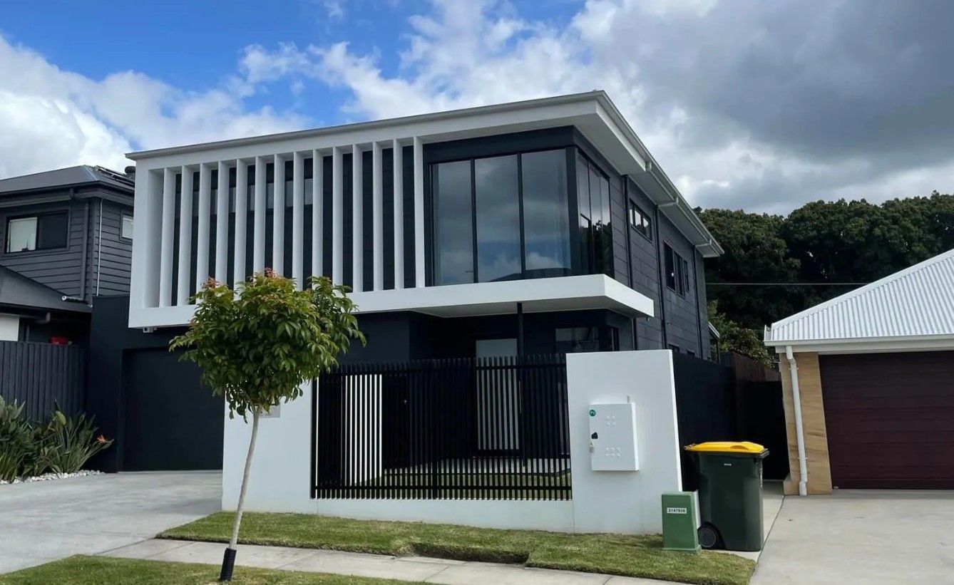 A Modern House with A Black Fence and A Large Window — Solarmaster in Brisbane, QLD