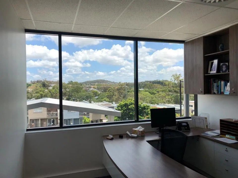A Office with A Large Window and A Desk with A Computer on It — Solarmaster in Murarrie, QLD