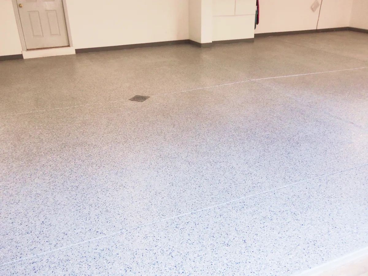 Gray speckled concrete garage floor.