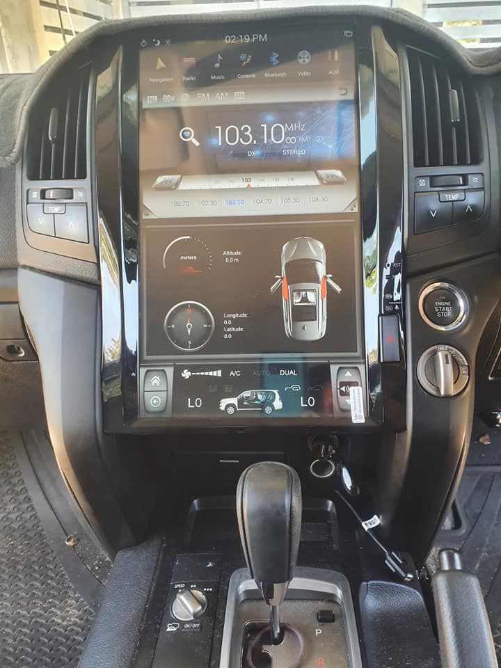 The dashboard of a car with a large screen that says 103.1 on it — Townsville Car Audio Excellence in Townsville, QLD