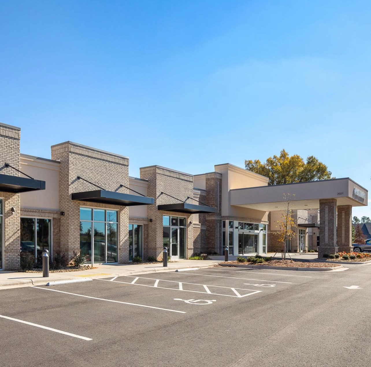A large building with a handicapped parking spot in front of it
