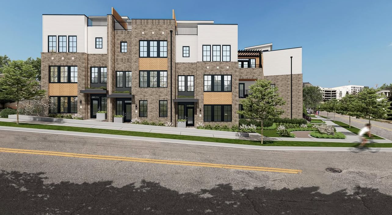 An artist 's impression of a row of apartment buildings next to a street.