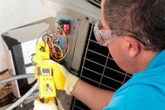 Technician Checking AC Unit — Electric Heating System Service & Repair in Bristow, VA