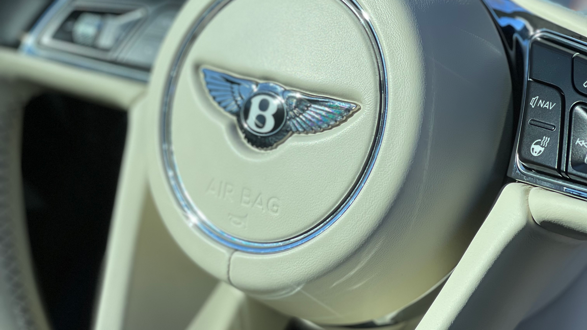 A close up of a bentley steering wheel
