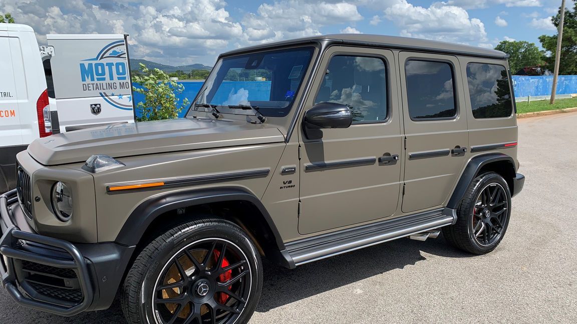 A mercedes benz g63 amg is parked in a parking lot.
