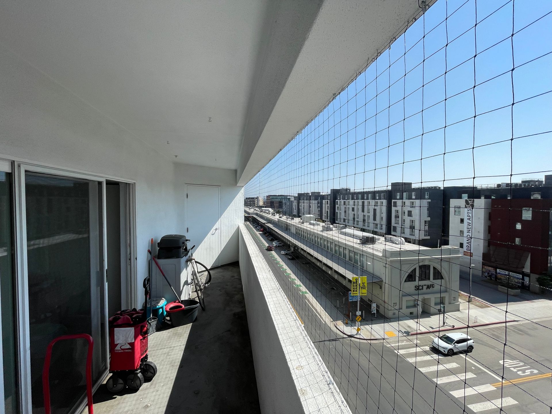 a balcony with a view of a city street