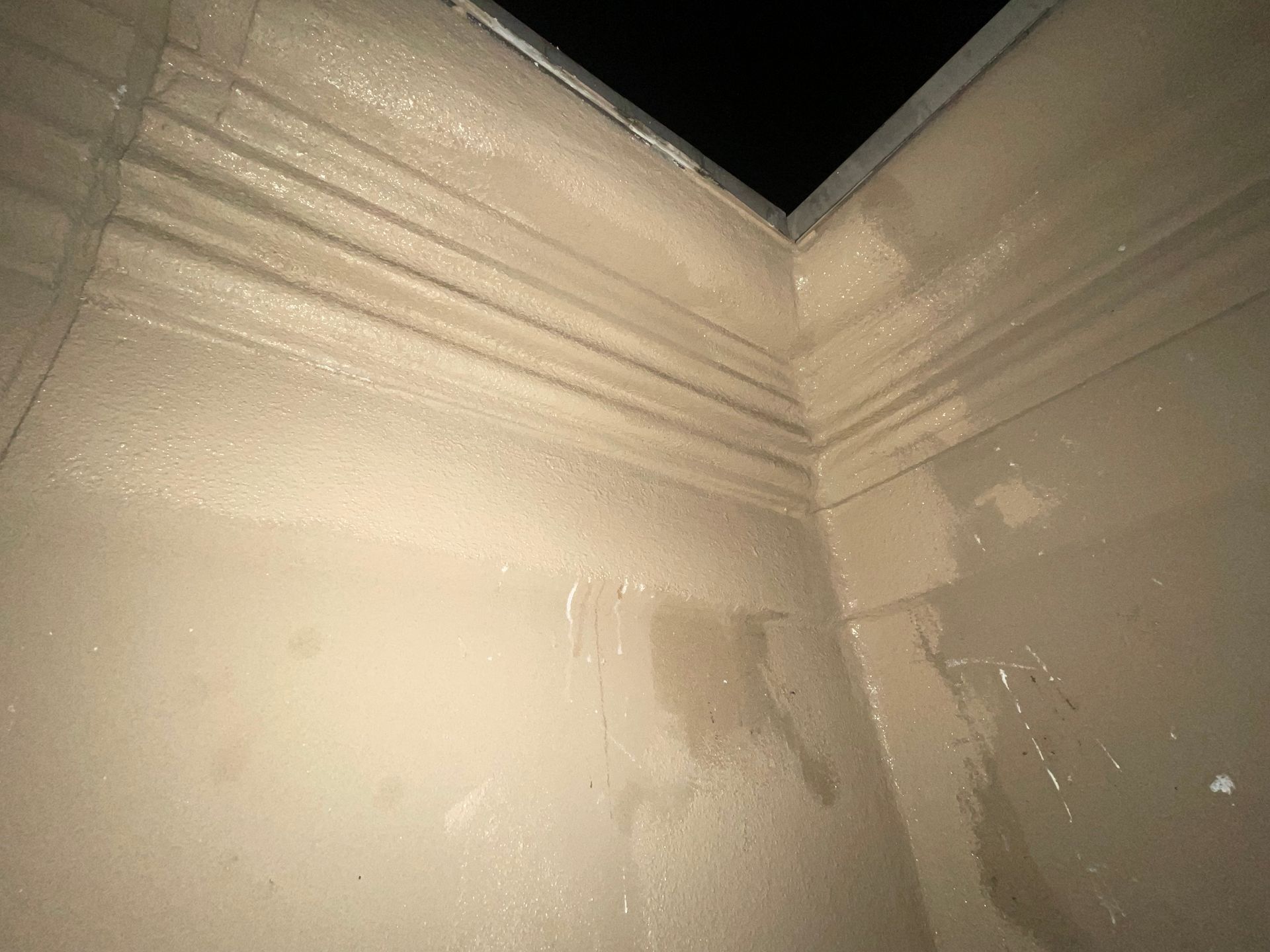 a close up of a corner of a wall with water coming out of it