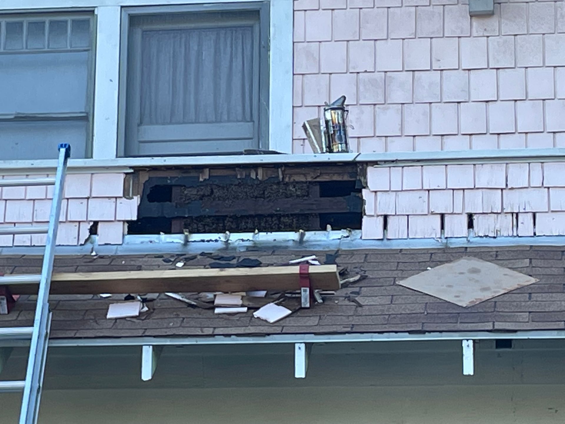 a ladder is sitting on the roof of a house