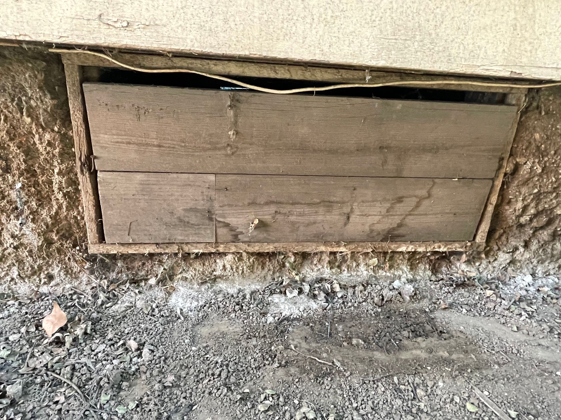a wooden door is sitting on the ground next to a wall