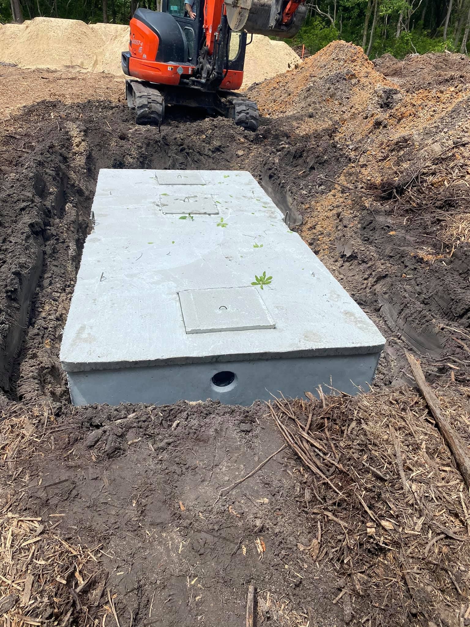A large concrete slab is sitting in the middle of a dirt field.