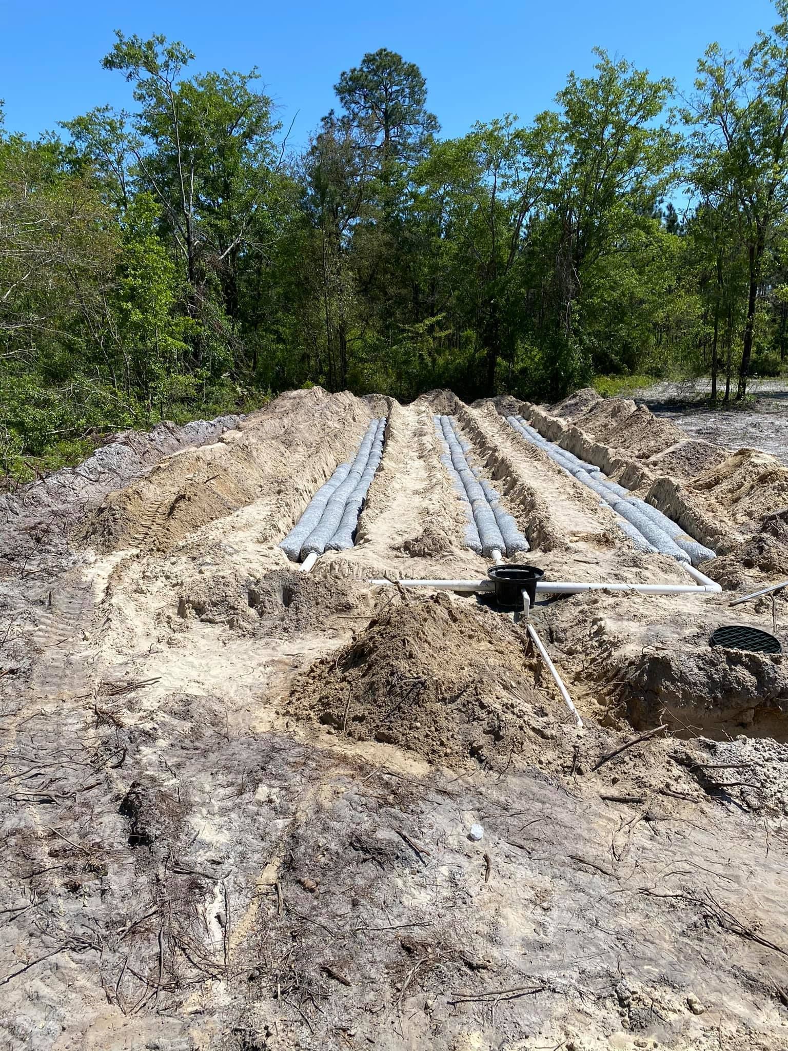 A large pile of dirt and trees in the background.