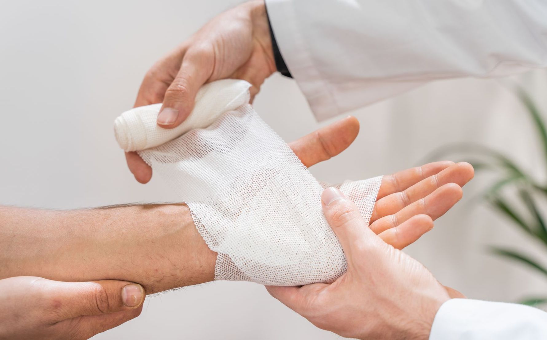 Doctor putting medical bandage on patient