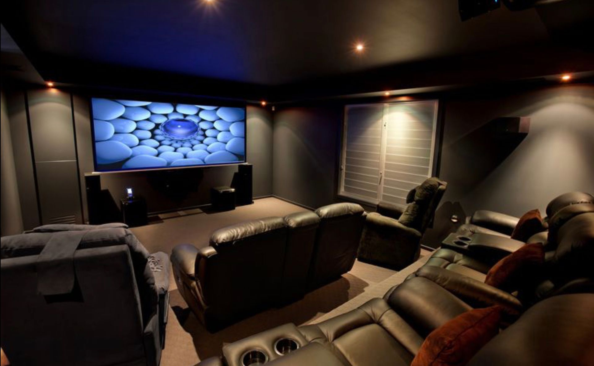 A home theater with a large screen and a lot of seats