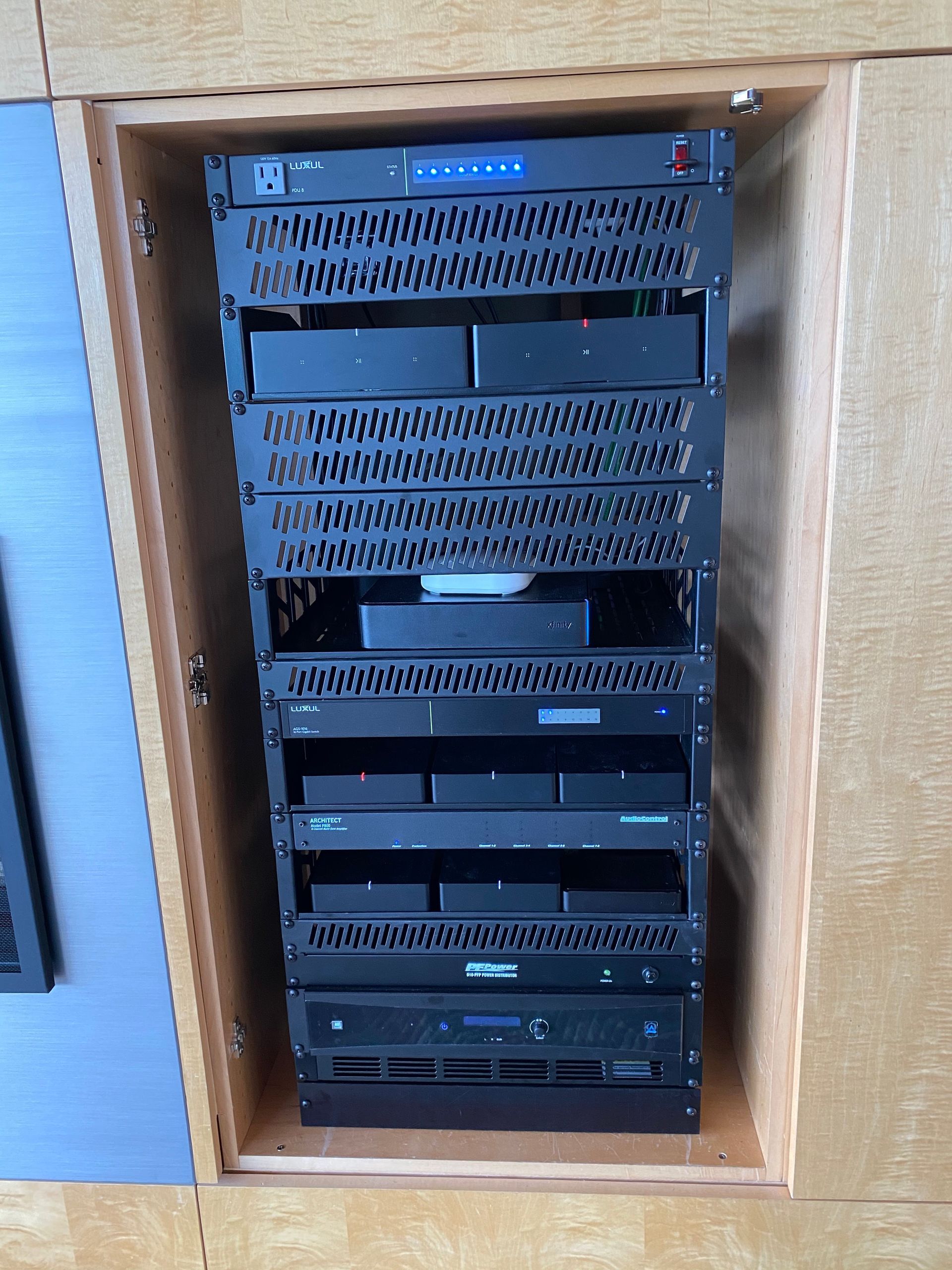 A stack of servers in a wooden cabinet