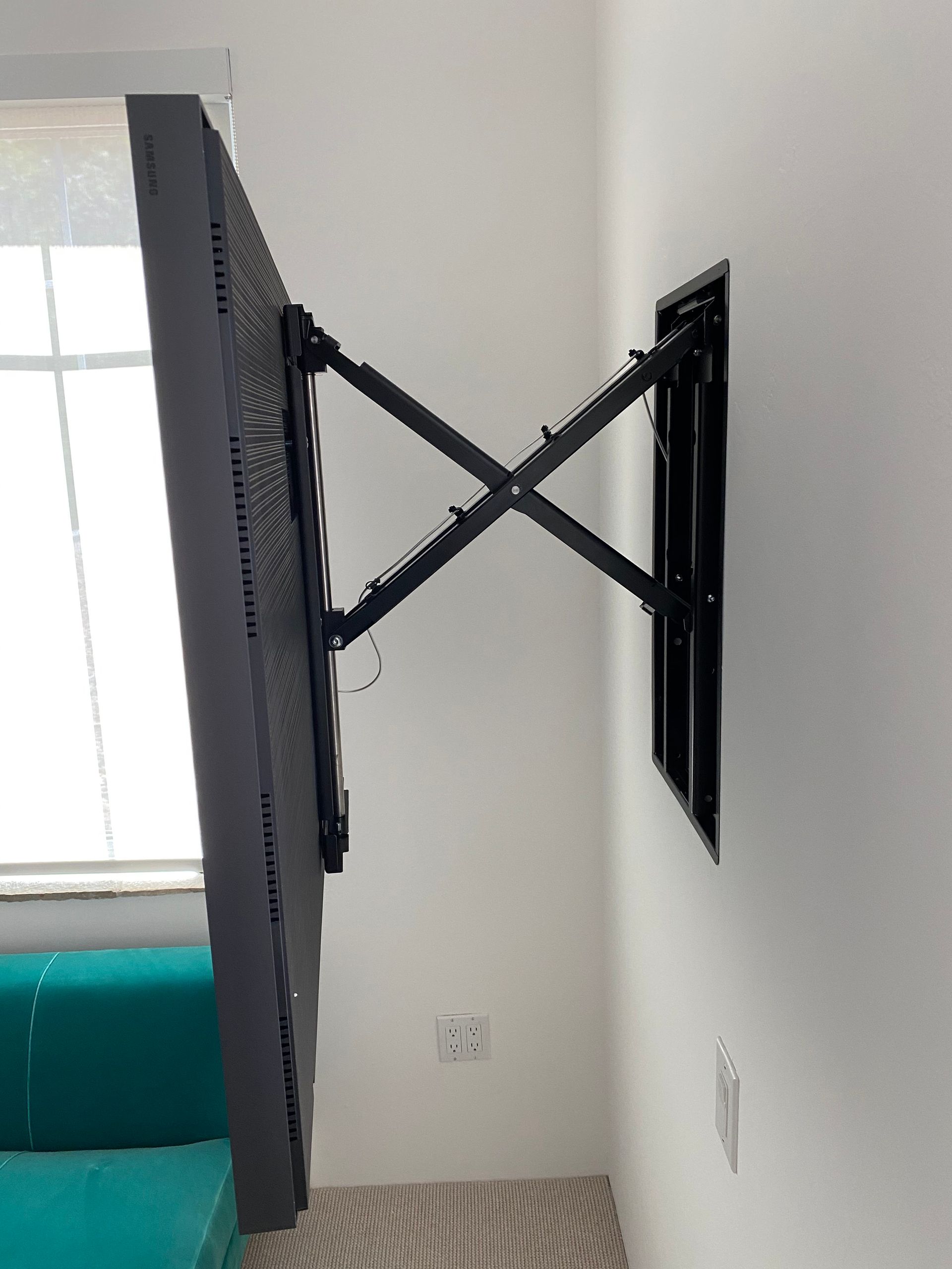 A flat screen tv is mounted on a wall in a living room.