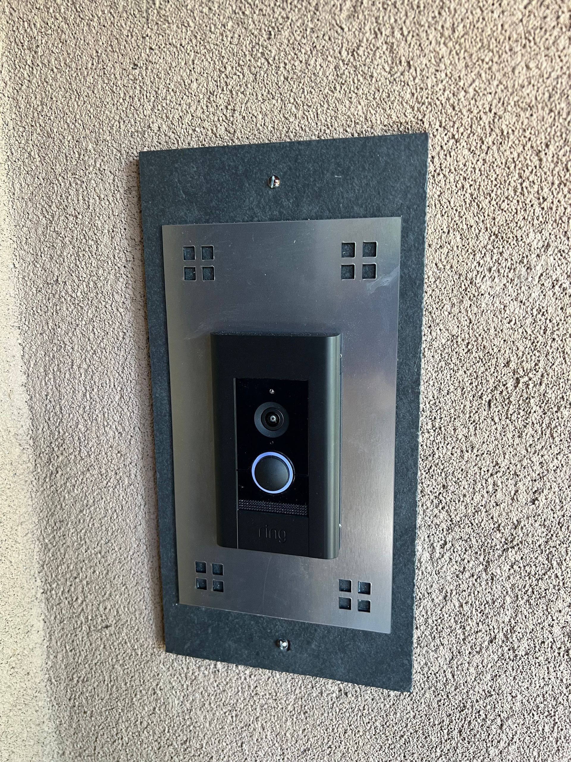 A large house with a garage and a driveway on a rainy day.