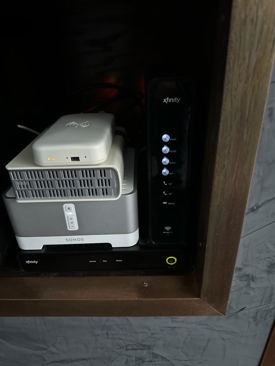 A large house with a garage and a driveway on a rainy day.