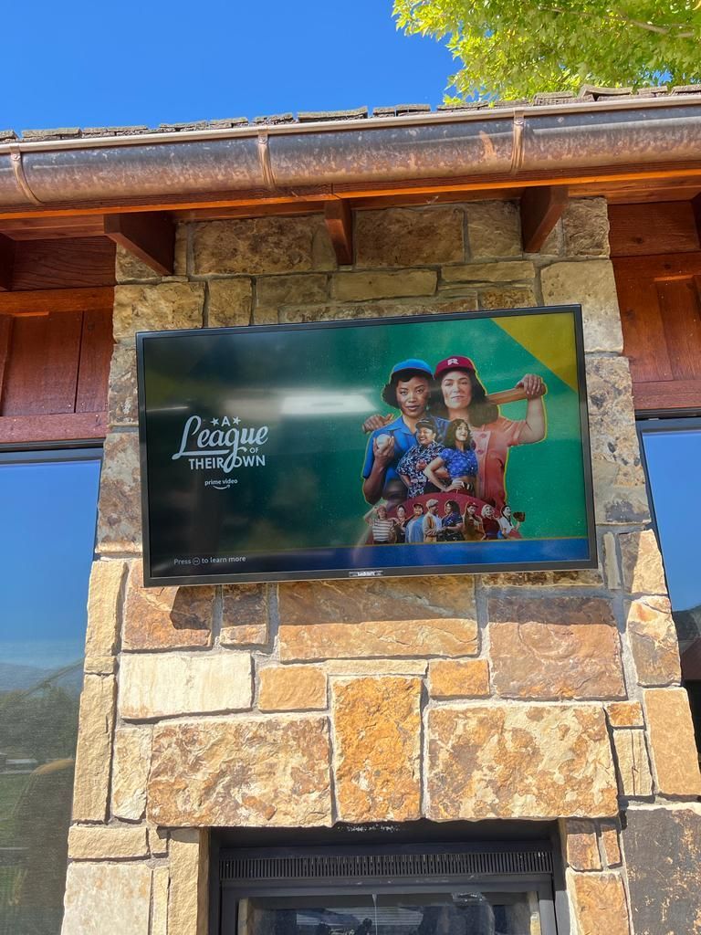 A large house with a lot of windows and a garage on a rainy day.