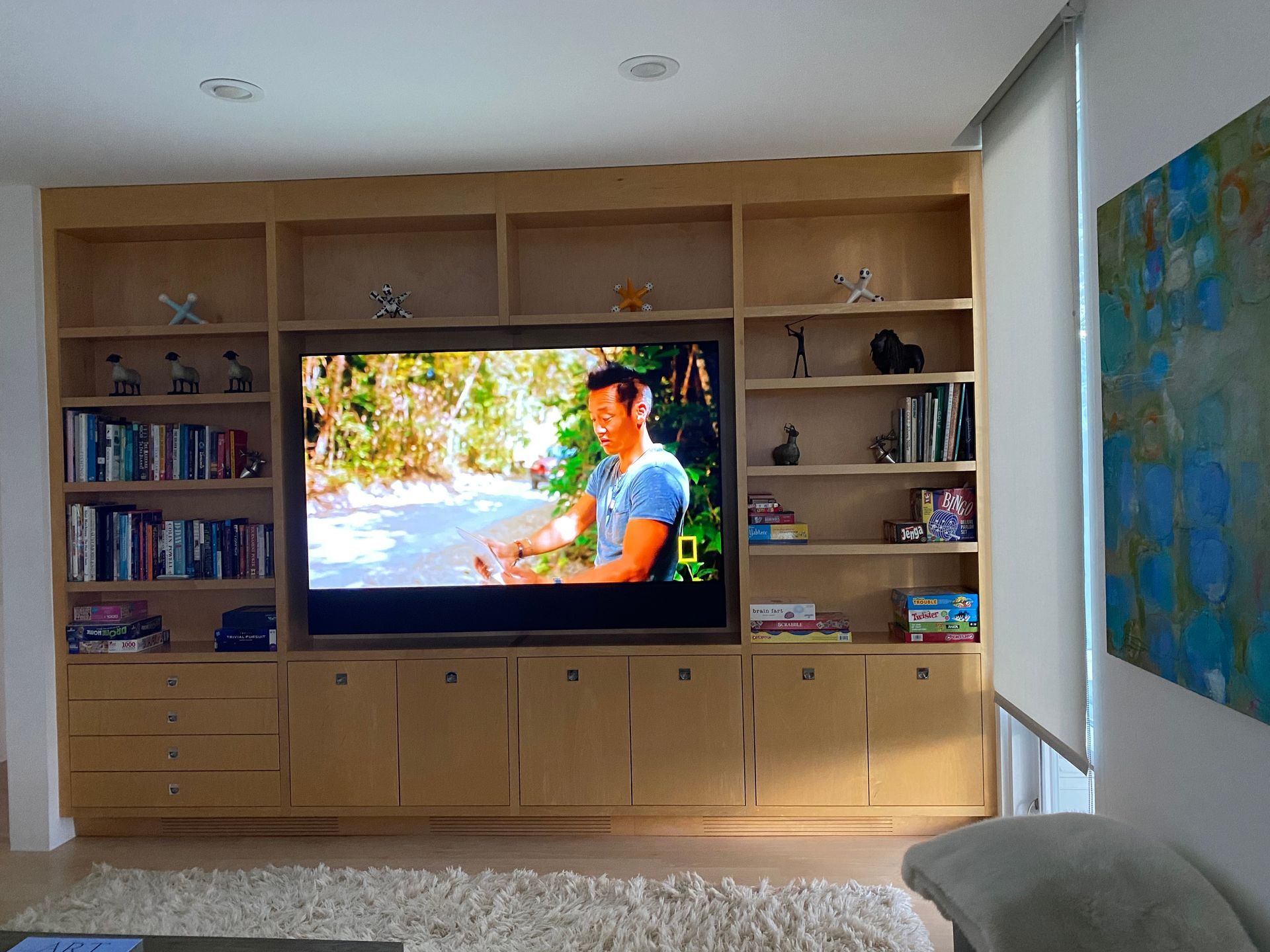 A large house with a lot of windows and a garage on a rainy day.