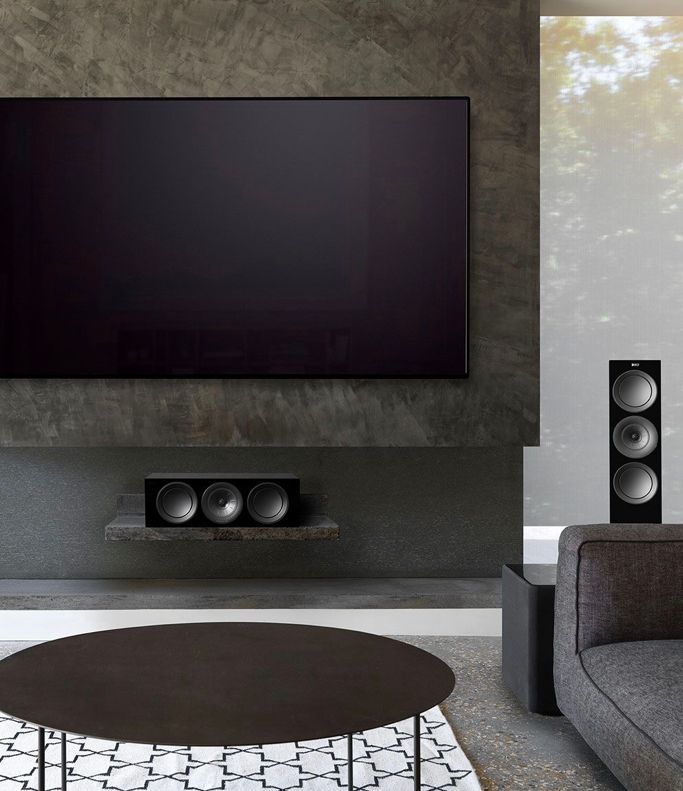 A living room with a large flat screen tv on the wall