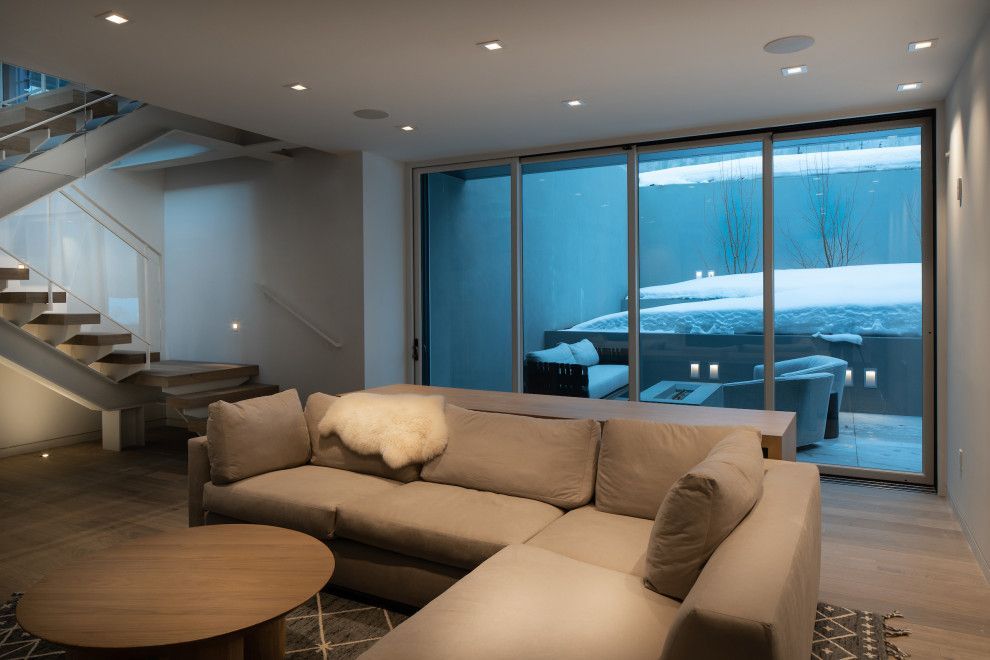 A living room with a couch , table , and stairs.