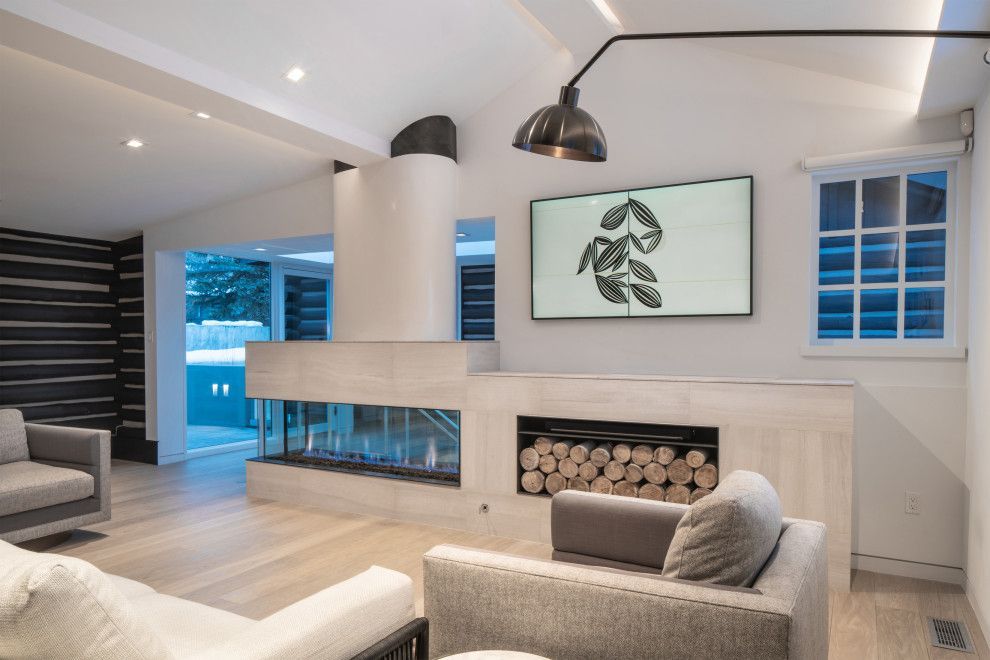 A living room with a fireplace and a flat screen tv on the wall.