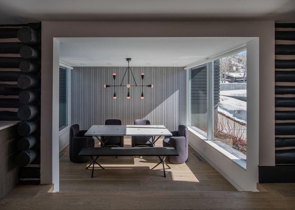 A dining room with a table and chairs and a bench.